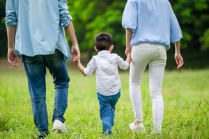 Parents holding hands with child